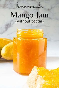 homemade mango jam without pectin in a glass jar next to two bananas on a white counter