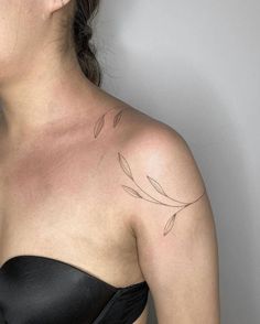 a woman with a tattoo on her shoulder