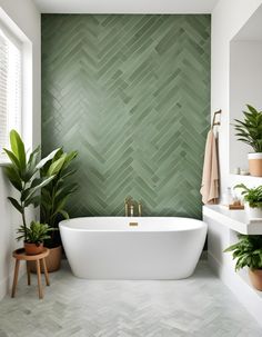 a white bath tub sitting next to a green wall