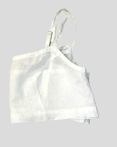 Luxe European Linen. Simple, comfortable, breathable, natural, non-toxic fabric with loop and button closure, and adjustable straps. Wear this in good health! BEST SELLER 100% Linen in handkerchief weight. Hem is about 2-3 " below bust and is rests above your waist. Wear it under or over a blouse. Also can be worn on its own as an alternative to a bra. Looks great with high waisted skirts or bottoms. Adjustable straps, button and loop back closure, and princess seams mold to your body. Item pair White Beach Top With Adjustable Straps, White Vacation Top With Straps, White Tops With Straps For Vacation, Vacation White Top With Straps, Summer White Tops With Adjustable Straps, Summer White Top With Adjustable Straps, White Tops With Adjustable Straps For Vacation, Everyday White Top With Adjustable Straps, Linen Top With Adjustable Straps For Vacation