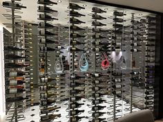 there are many wine racks in the room that have scissors and other items on them