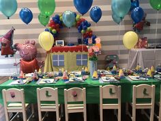 a table set up for a peppa pig themed birthday party with balloons and decorations