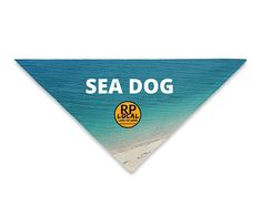 a dog bandana with the words sea dog on it in front of an ocean beach