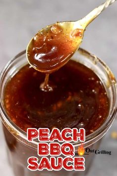 a spoon full of bbq sauce with the words peach bbq sauce on it