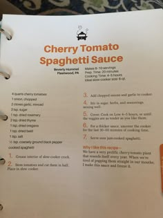 a recipe book is open to show information about the ingredients for cherry tomato spaghetti sauce