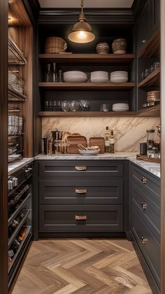 an open pantry with wooden shelves and black cupboards, white dishes on the counter