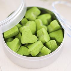 green heart shaped candies in a metal container