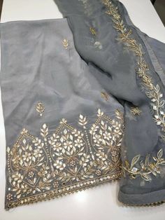 Item Overview ATHARVA Hand Embroidery Salwar Kameez/Grey Crepe Silk Shirt/Gota Patti Chiffon Dupatta/Custom Stitch Unstitch/Anarkali/Gift Dno. CH1839A Fabric:  * Shirt - Crepe Silk- Hand Embroidered Neck 2.5 Mts - Beautiful Hand Embroidery  * Dupatta: Chiffon Chinnon Dupatta- All over Exclusive Gota Patti Embroidery - 2.5 Mts- Latkans Tassels  * Bottom Santoon Silk 2.5 Mts. Excusive Hand Embroidered Party Wear Punjabi Suit. Customization: * Fabrics Customization: Designs Can be made in different Gota Patti Dupatta, Designer Gray Set With Zari Work, Festive Gray Zari Work Sets, Gray Resham Embroidery Kurta For Wedding, Gray Anarkali Set With Zari Work, Gray Anarkali Set With Dupatta, Gray Anarkali Set For Festive Occasions, Gray Festive Sets With Resham Embroidery, Festive Gray Sets With Dupatta