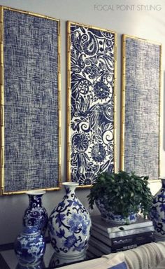 three blue and white vases sitting on top of a table