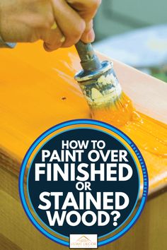 a person using a paint brush to finish a wooden table with the words how to paint over finished or stained wood?