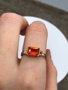 Vintage 10k yellow god ring with a large orange citrine centre and little diamonds on the side. One of the diamonds is missing and there is some wear on the band. Offered at a better price because of these flaws. Very vibrant and in a clean modern style. By Michael Hill Jewellers. Fits size 7 2.81 grams in weight Fine Jewelry Orange Diamond Ring, Fine Jewelry Orange Sapphire Anniversary Ring, Orange Diamond Gemstone Ring, Orange Diamond Rings With Gemstone, Orange Sapphire Ring For Anniversary, Orange Diamond Ring For Anniversary In Fine Jewelry Style, Orange Diamond Ring For Anniversary, Classic Orange Diamond Ring, Orange Diamond Ring With Center Stone