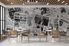 a dining room with newspaper wallpaper and wooden ceilinging, along with tables and chairs