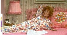 a woman laying on top of a bed next to a pillow with the chicago black hawks logo