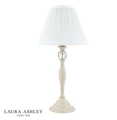 a lamp with a white shade on it and the words, lauren ashley since 1932