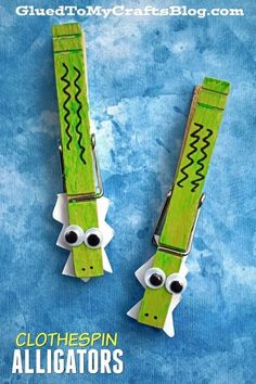 two green alligators made out of clothes pins with googly eyes and one eye on each end