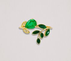 "Floral" 14 kt solid gold ring with enamel green leaves, natural emerald and diamonds. Genuine Emerald ring. Enamel ring. Flower Ring. Twig ring. Leaves ring. Plant nature jewelry. Botanical engagement ring. Open Ended Ring. May birthstone. By Daizy Jewellery. Metal type: 14kt solid gold Central stone: Natural Emerald: pear shape, green color, VS-SI clarity, 1 piece 0.80-0.90 ct. Surrounding stone: Diamond: 4 pieces x 0.01 ct - total 0.04 ct, G/VS, round brilliant cut. Some leaves are covered wi Flower Gold Ring, Gold Ring With Emerald, Ring With Emerald, Leaves Ring, Gold Leaf Rings, May Birthstone Rings, Twig Ring, Green Ring, Ring Flower