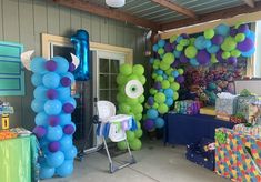 balloons and streamers are set up in front of the door to an outside party