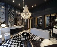 a black and white living room with chandelier