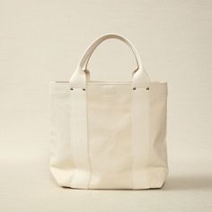 Unbleached Canvas Medium Tote 16.5" x 5.5" x 12.6" Made in Japan Threadline is a Japanese-manufactured line of heavy canvas bags designed for everyday use. Practical White Cotton Canvas Bag, Everyday Waxed Canvas Cotton Bag, Large White Canvas Bag For Everyday Use, Large White Everyday Canvas Bag, Daily Rectangular Canvas Bag, Classic Cotton Canvas Bag, White Cotton Canvas Bag With Leather Handles, Classic Rectangular Waxed Canvas Bag, Classic Beige Cotton Canvas Bag