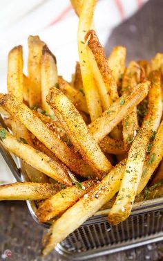 french fries with seasoning sitting in a basket