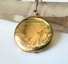 "a gorgeous locket made in 10k gold and of a substantial size.  beautiful floral engraving on the front and initials on the back,  i believe they are HFP.  locket opens near the top and it looks as though photos have never touched those pristine places.  inside is marked B&N and 10k.  the clasp on the chain is also marked 10k.  this is in almost new condition, with a few light scratches. diameter of locket:  1 and 1/16\" thickness:  3/16\" length of chain:  just over 16\"" Antique Gold Locket, Seed Pearl Ring, Victorian Locket, Engraved Locket, Picture Locket, Moon Bracelet, Round Locket, Locket Pendant Necklace, Victorian Gold