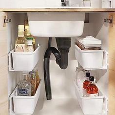 a sink and some containers under a faucet