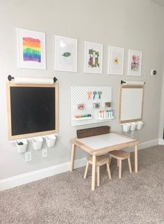 a child's playroom with two tables and chalkboards on the wall