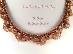 the necklace is made with copper beads and glass beadwork, which are handmade by susan sasson