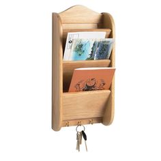 a wooden shelf with books and keys hanging from it