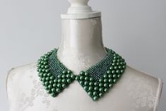 Handmade collar necklace with round pearls in emerald green / dark green color, in different size and clear green beads and opalescent beads. Ribbon tied on the back - adjustable for every neck size. Pointed shape. Peter pan collar type. Every single bead is handsewn.  Collar gives a chic touch to simple dresses and blouses.  One size. Handmade item. Wonderful gift for women or female friends. Please check out other items in my shop. You can find there collars in different shapes, colors and materials. Great to wear everyday and also for special occasions. Necklace With Pearls, Beaded Collar Necklace, Emerald Green Dresses, Single Bead, Green Pearls, Beaded Collar, Green Beads, Female Friends, Green Dark