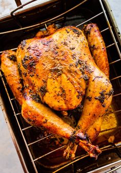 a roasted chicken sitting on top of a grill