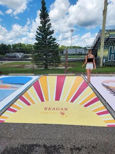 a woman standing in front of a colorful ramp