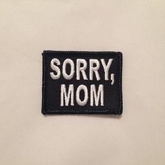 a black and white patch that says sorry, mom