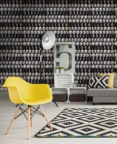 a living room with black and white wallpaper, yellow chairs and a gray couch