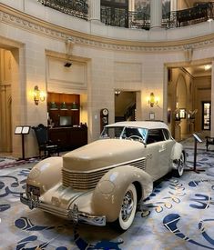 an antique car is on display in the lobby