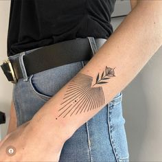 a woman's arm with a tattoo on it that has an arrow in the middle