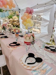 a table set up with balloons and plates