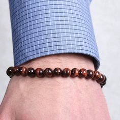 Handsome men's bracelet with reddish brown tiger's eye beads and sterling silver clasp. Elegant Hand-strung Brown Bracelet, Elegant Brown Hand-strung Bracelet, Elegant Brown Stretch Bracelet With Gemstone Beads, Classic Brown Bracelets For Gift, Elegant Brown Stretch Bracelet With 8mm Beads, Elegant Brown Beaded Bracelets With 8mm Beads, Lose A Stone, Brown Tiger Eye, Tiger Eye Bracelet