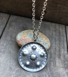 "Vintage pewter pendant necklace by Jorgen Jensen, Denmark. The hand made pendant is round with a nice pattern and raised edges. The diameter measures 2\" / 5cm and the chain measures 36\" / 91cm. Marked: \"PEWTER Jorgen Jensen HANDMADE DENMARK 158\" It's from the 1960's and shows minor wear, such as small scratches, for it's age. Please see all pictures." Silver Round Pendant Medallion Necklace, Vintage Round Medallion Necklace Nickel Free, Engraved Round Pendant Medallion Necklace, Antique Medallion Necklace With Round Pendant, Handmade Antique Silver Medallion Necklace, Antique Silver Medallion Necklace, Handmade Silver Vintage Medallion Necklace, Silver Medallion Necklace, Handmade Metal Medallion Necklace With Round Pendant