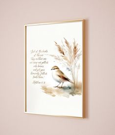 a bird is sitting on the ground next to a wall with a quote written in it