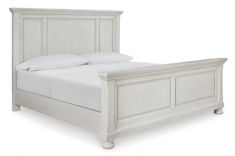 a white bed with two pillows on top of it's headboard and foot board