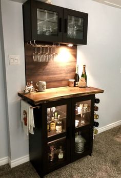 a bar with wine glasses and bottles on it