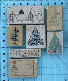 several wooden stamps with christmas trees on them and numbers in the middle one is numbered