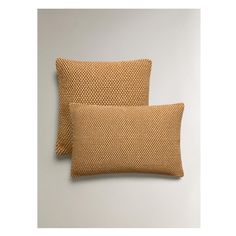 two orange pillows sitting next to each other