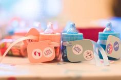 several baby bottles with labels on them sitting on a table next to some other items