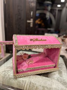 an open pink box sitting on top of a table