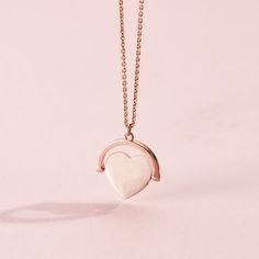 This gorgeous Heart Spinner Necklace is made from 18ct Rose Gold plated Sterling Silver. The design features a spinning heart pendant suspended from one of our classic trace chains.  The Spinning Necklace is reminiscent of traditional spinning necklaces with a modern luxe twist. Each necklace is handcrafted in our Brighton workshop from solid sterling silver then plated in 18ct Rose gold plate. Pendant measures approx 17. 2mm x 18. 3mm. Comes suspended on 18" chain. 18ct Rose Gold plated Sterlin Rose Gold Heart Charm Jewelry With Pendant, Rose Gold Heart Charm Pendant Jewelry, Rose Gold Heart Pendant Jewelry With Heart Charm, Rose Gold Open Heart Charm Necklace With Delicate Chain, Rose Gold Heart Charm Jewelry, Delicate Rose Gold Heart Necklace For Valentine's Day, Minimalist Rose Gold Heart Cut Jewelry, Rose Gold Charm Necklaces For Anniversary, Heart-shaped Rose Gold Charm Necklace With Chain