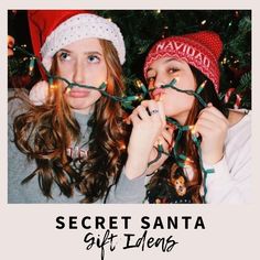 two girls wearing christmas hats and lights in front of a christmas tree with the caption secret santa gift ideas