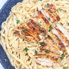 some chicken and noodles on a blue plate