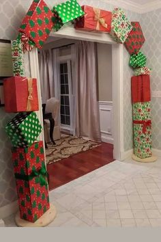 an arch made out of wrapped presents in the hallway